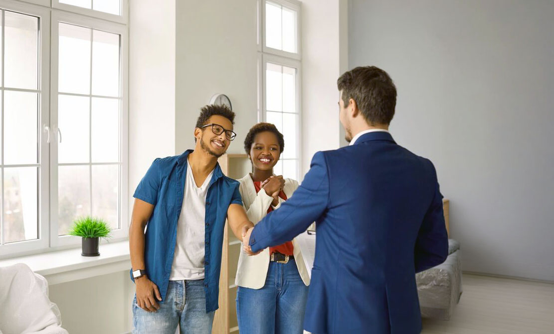 A Euro Stars adviser handing keys to new tenants across the desk